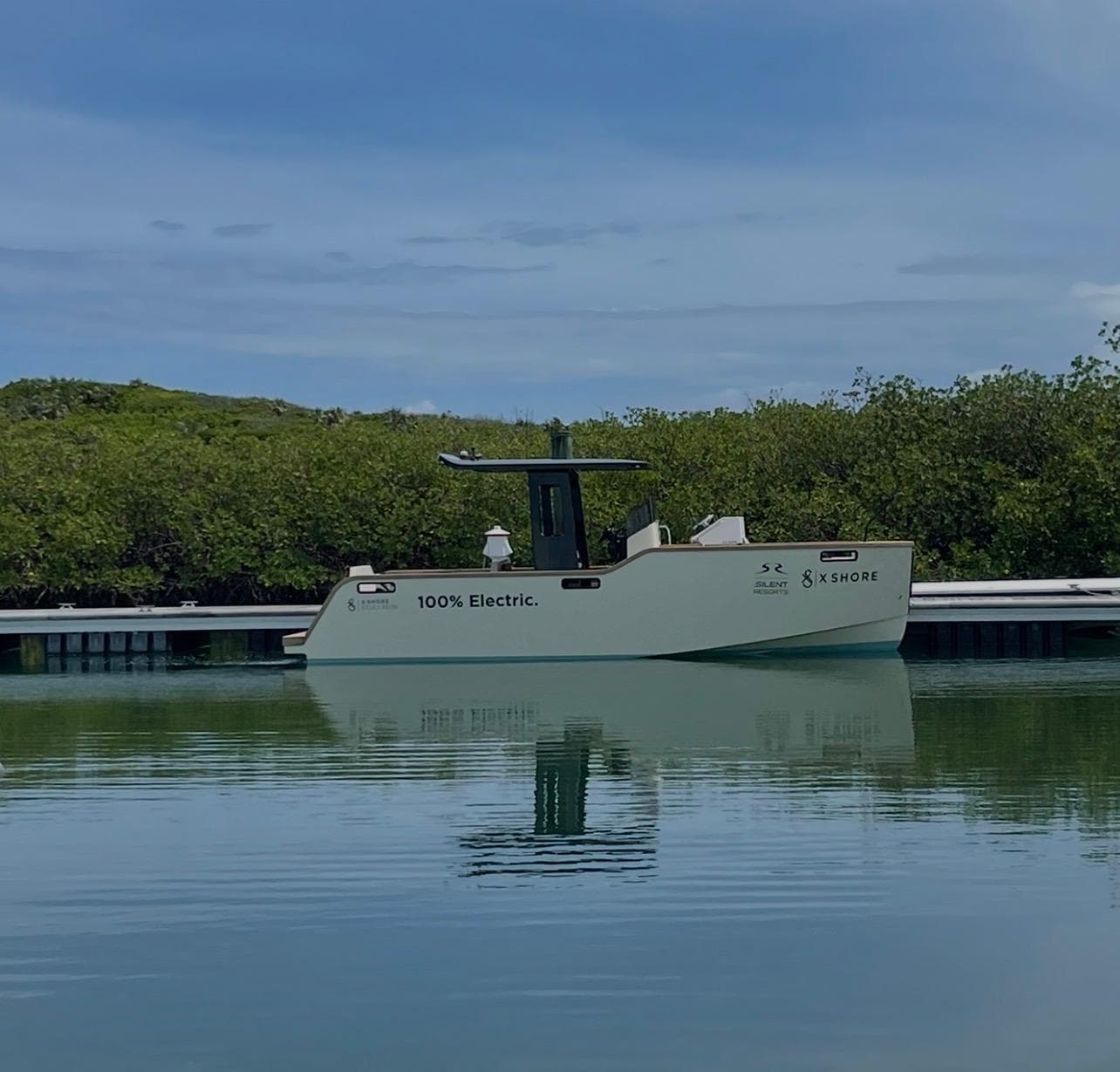 Observation — a fully electric X Shore boat moored in a calm Bahamian cove